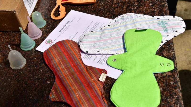 Young female students in Karnataka classroom learning about menstrual health options and sustainable hygiene practices together.