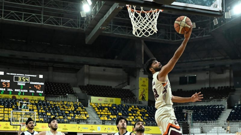 Punjab basketball players celebrating victory on court at National Basketball Championships, arms raised in triumph