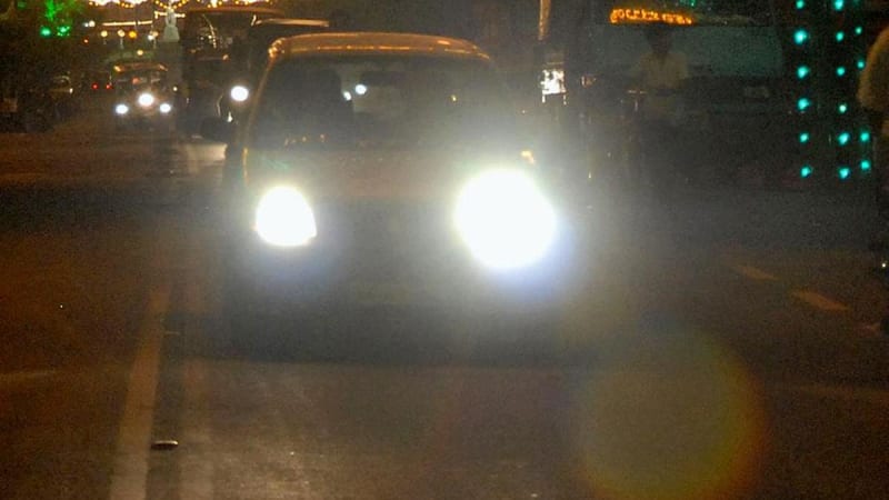 Bengaluru traffic police officer conducting vehicle lighting inspection to ensure road safety and proper headlight compliance