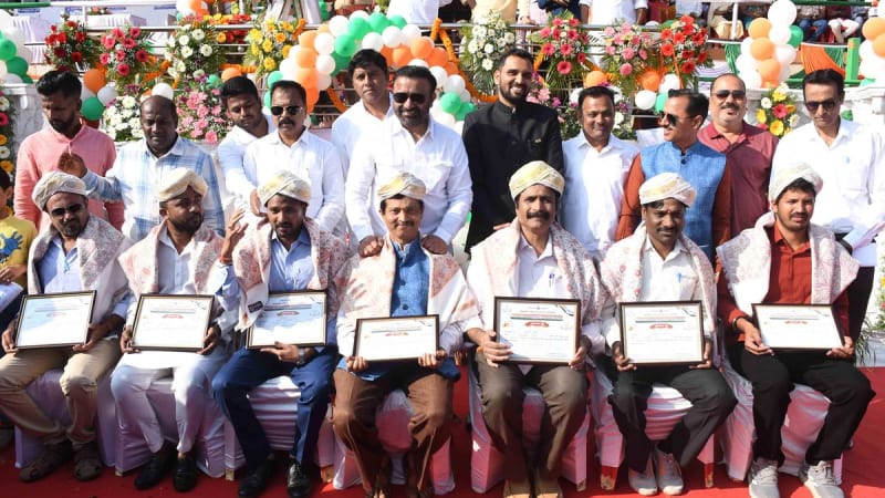 Indian flag unfurling ceremony with students and officials gathered at outdoor celebration
