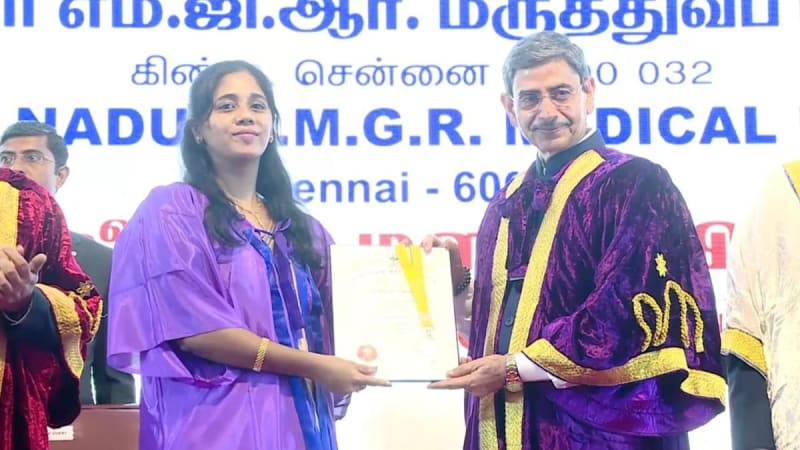 Large graduation ceremony with thousands of healthcare students in academic regalia receiving their degrees