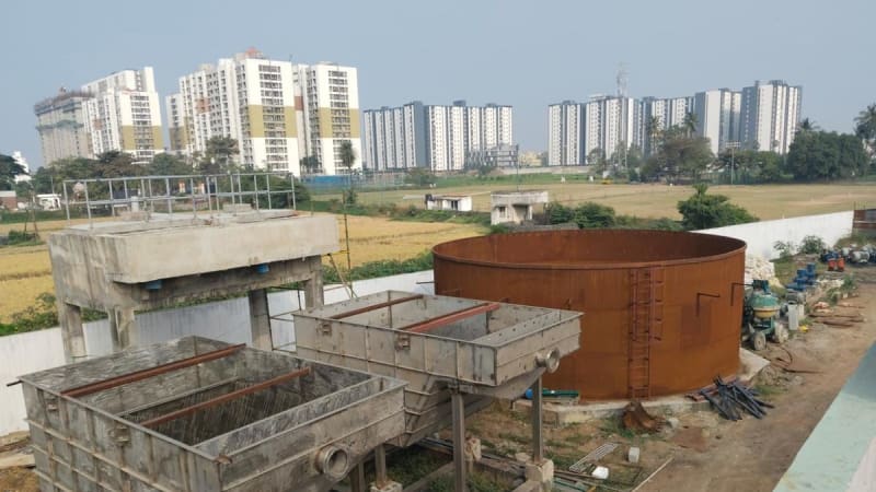 Modern water treatment facility beside a calm lake in Chennai, India
