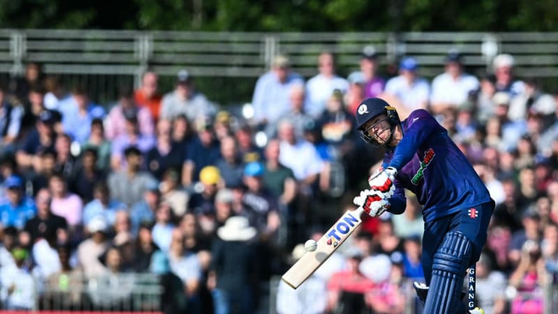 Scotland cricket team players celebrating together on field in blue uniforms