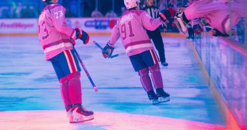 Spokane Chiefs forward Ethan Hughes celebrating goal in pink Hockey Fights Cancer uniform