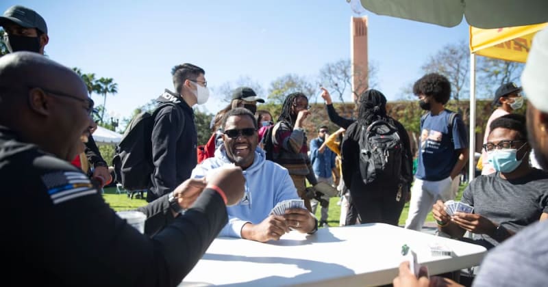 Students gathered at outdoor USC campus celebration with vendors and music for Black History Month