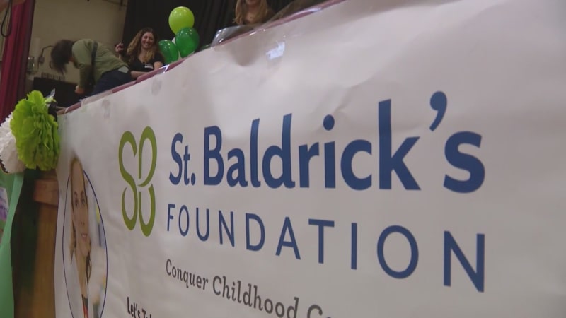 Young blind man with cane smiling, South Side Chicago cancer survivor helping other kids