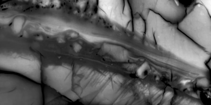 Scientists conducting earthquake research in laboratory with specialized equipment measuring seismic energy distribution and rock samples