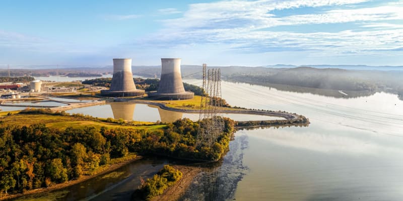 Futuristic sodium-ion battery cells and next-generation nuclear reactor facility representing clean energy breakthrough technologies