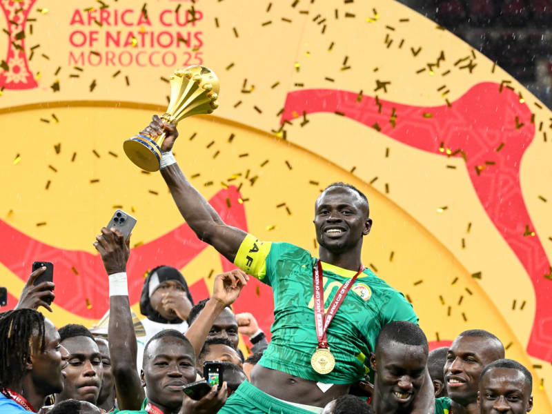 Senegal's Sadio Mane hoists AFCON trophy high while celebrating with teammates in Rabat