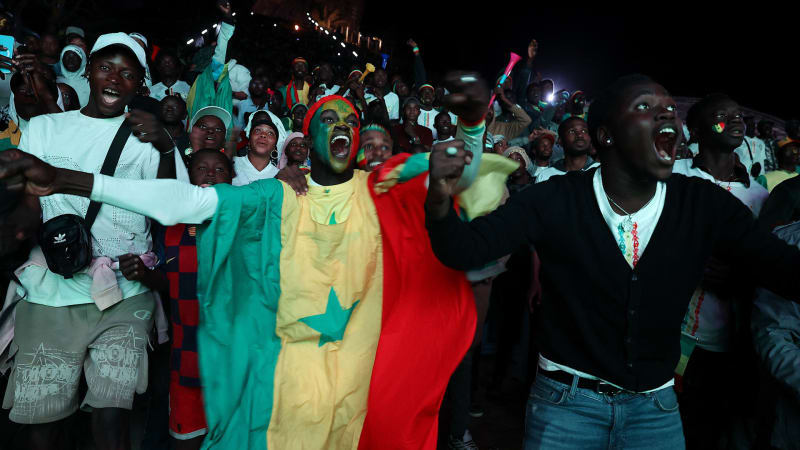 ** Senegalese football fans celebrate in streets waving national flags after AFCON championship victory
