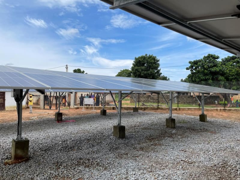 Woman inspecting solar panel at all-women manufacturing facility in Cape Town, South Africa