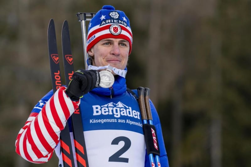 Campbell Wright smiling on podium with silver medal at biathlon world championships in Switzerland