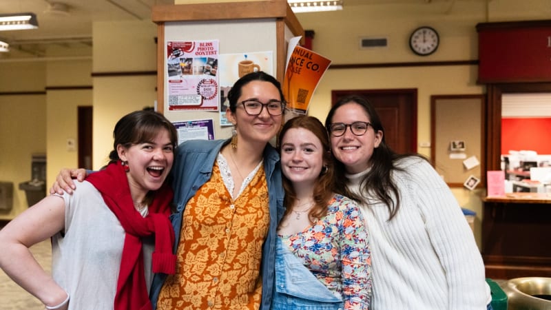 Davidson College students gathering at outdoor celebration with coffee and snacks for kindness day