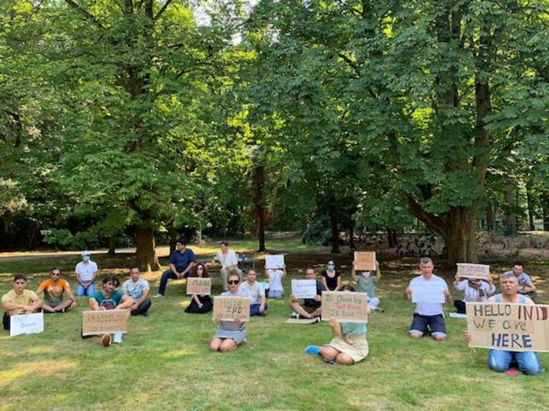 Diverse group of professionals celebrating visa approval in Netherlands immigration office