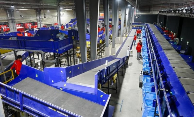 Modern automated sorting facility with conveyor belts processing packages in Egypt's new logistics center