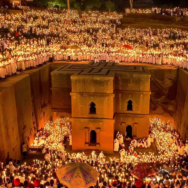 Ancient rock-hewn churches of Lalibela, Ethiopia, carved from stone with pilgrims gathering for Orthodox Christmas celebrations