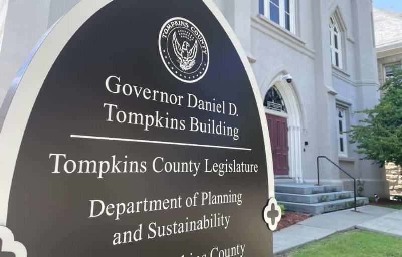 Aerial view of Ithaca, New York showing city buildings and surrounding green landscape