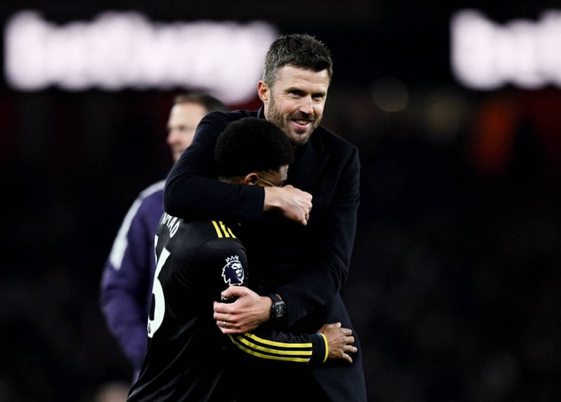 Michael Carrick celebrating on the sideline during Manchester United's victory over Arsenal