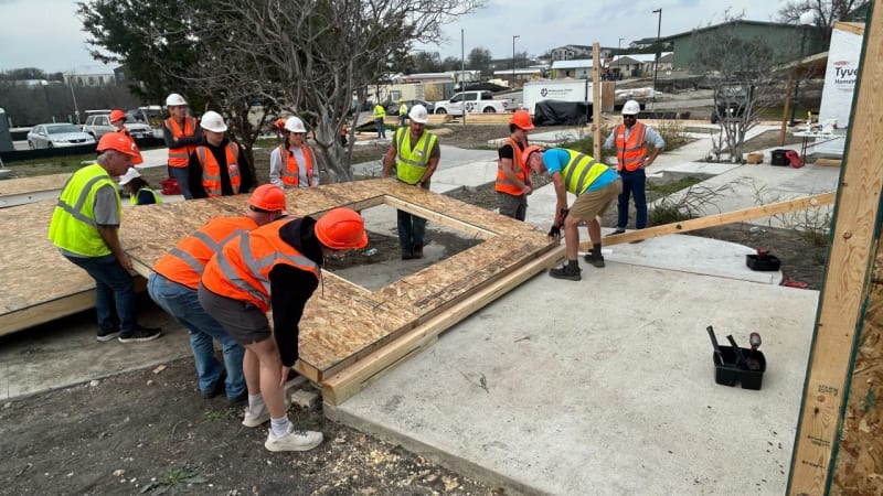 Volunteers working together to construct a small home at Community First Village in east Austin, Texas, building hope and community.