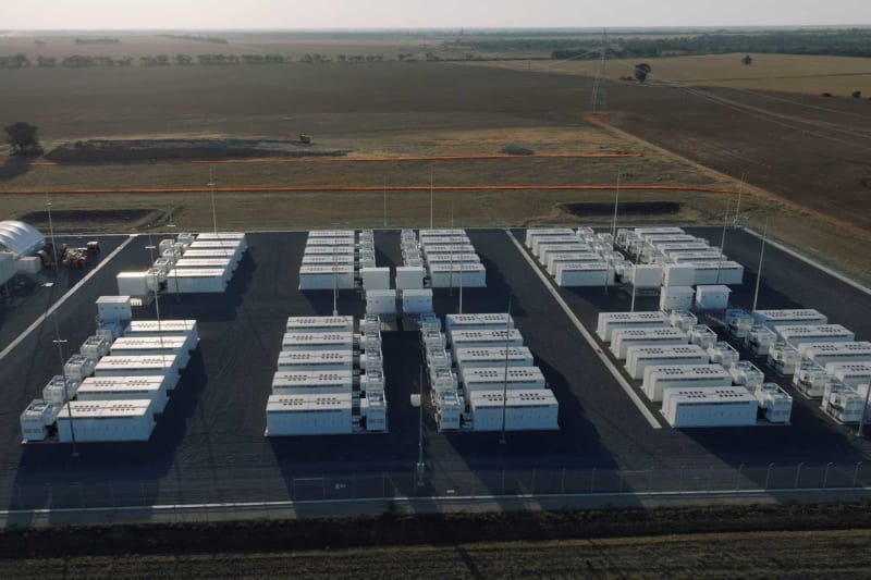 Solar panels and battery storage facilities under construction showing clean energy investment growth