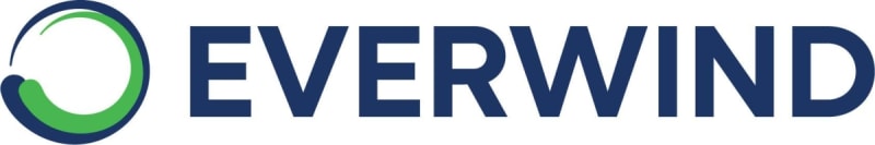 Wind turbines standing tall across Nova Scotia landscape with blue sky backdrop