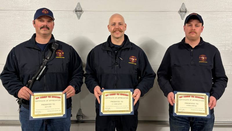 Troy Township firefighters receiving certificates at trustee meeting for heroic grain silo rescue