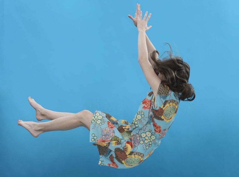 ** Newsroom editor having serious but supportive conversation with young journalist at desk