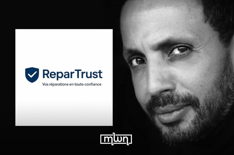 Mechanic using digital tablet in automotive repair shop in Morocco