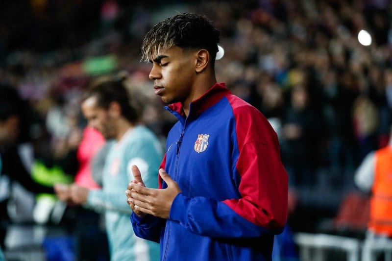 Young soccer player Lamine Yamal in Barcelona uniform during a match