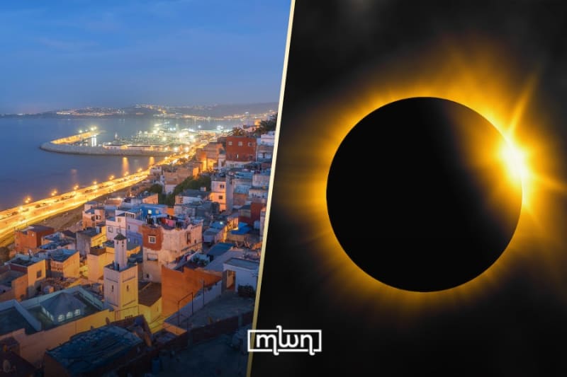 Total solar eclipse showing sun's corona around dark moon silhouette over Tangier, Morocco skyline