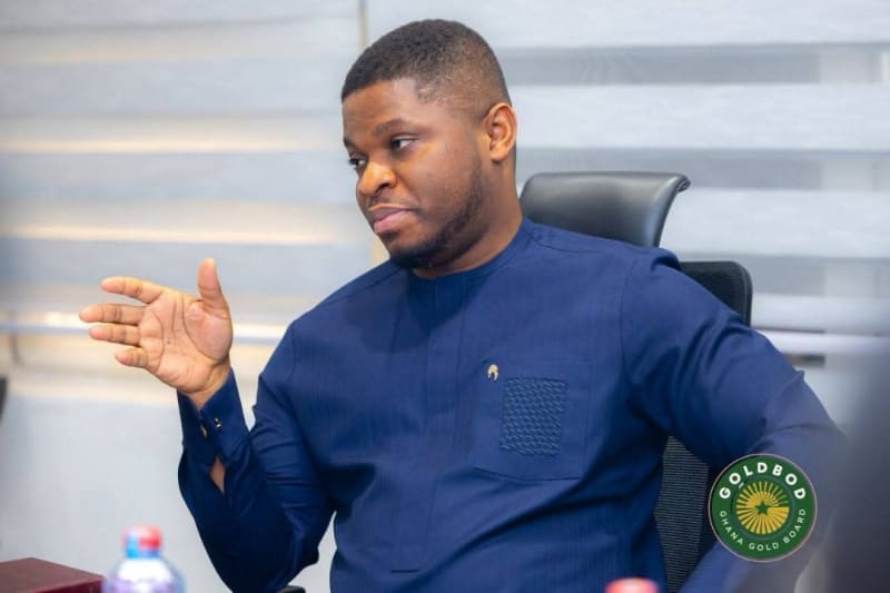 Ghana Gold Board officials reviewing successful gold reserves programme with chart showing positive economic growth trends