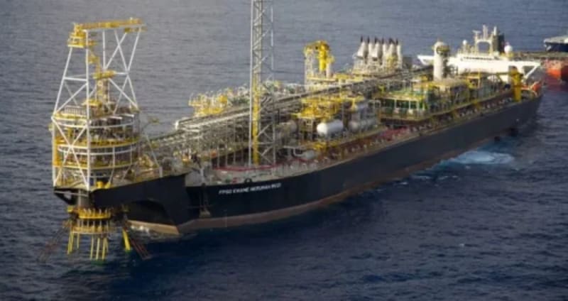 Modern FPSO vessel operating in offshore oil field with blue ocean waters surrounding the floating platform facility
