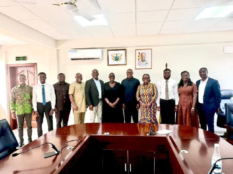 Government officials, university administrators, and student leaders gathered around table in collaborative stakeholder meeting at University of Ghana campus