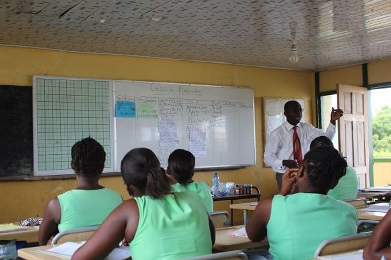 Ghanaian students engaged in English language learning, celebrating educational achievement and global connectivity in modern classroom setting