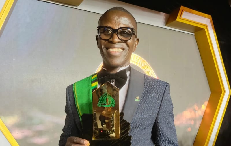 Fishing boats anchored along Ghana's Atlantic coast with blue ocean waters stretching to horizon