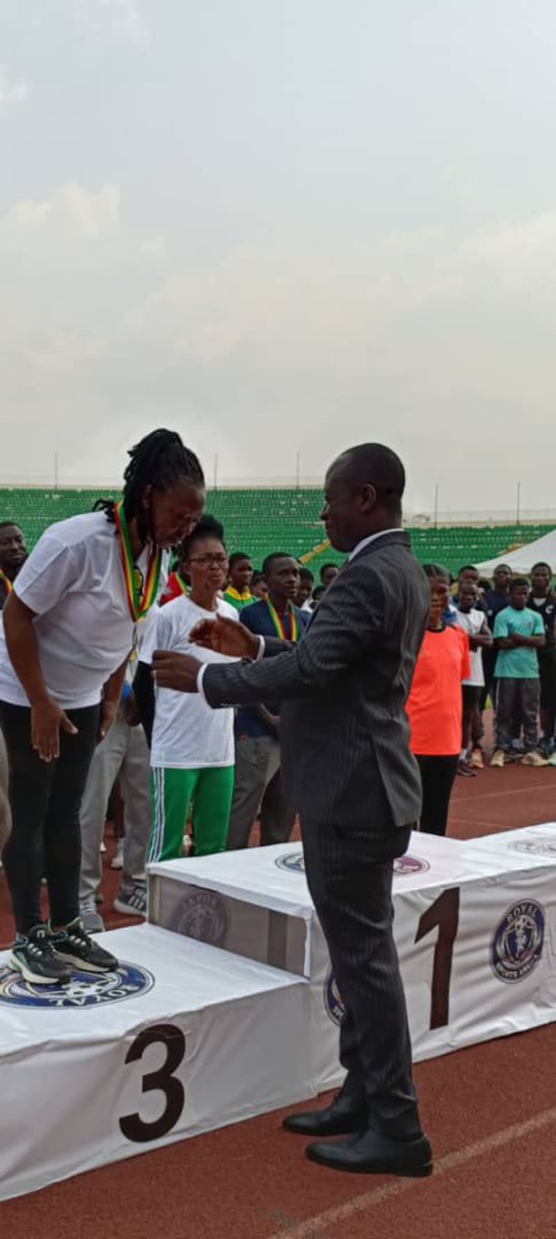 Mature athletes competing on track at Baba Yara Sports Stadium in Kumasi, Ghana