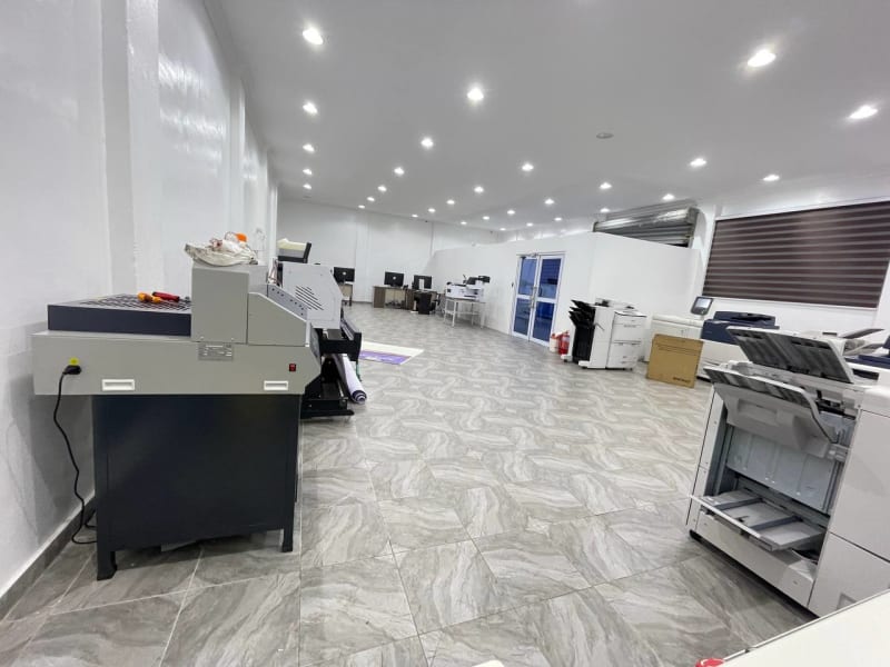 President Mahama standing at modern digital printing facility with GPCL staff celebrating new technology centre opening