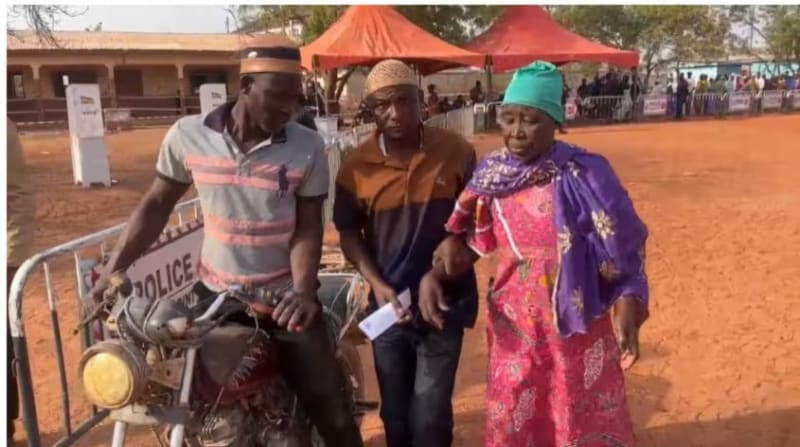 Elderly Ghanaian woman arriving at voting center to cast ballot in political primary