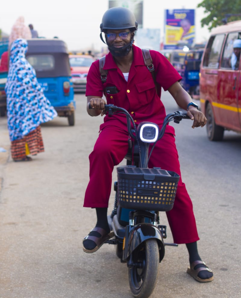 Ghana Journalist Rides E-Bike Through Traffic to Fight Smog