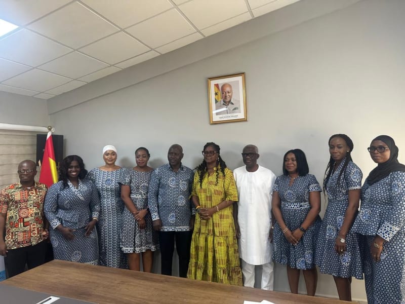 Bank representative presenting ceremonial check to Ghana Sports Fund officials at donation ceremony