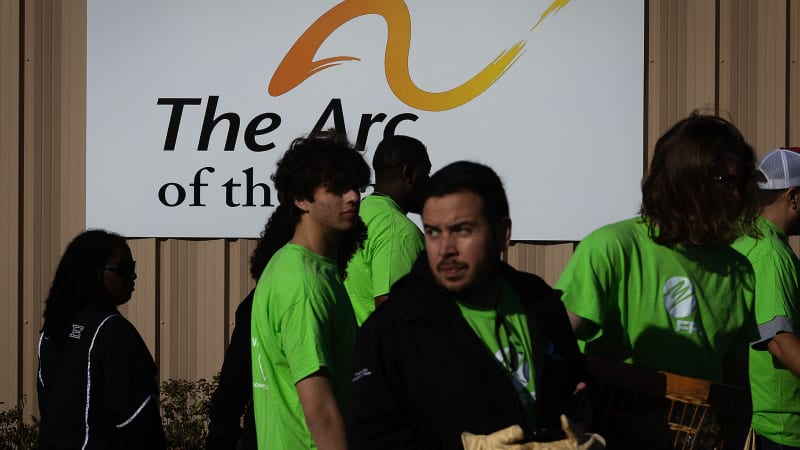 ** FPL volunteers working outdoors refreshing grounds at Arc of the Bay nonprofit facility