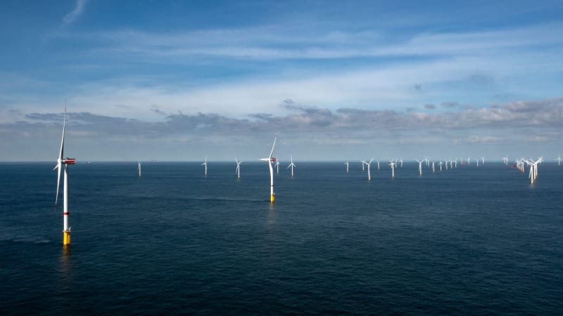 Offshore wind turbines rising from ocean waters near Philippine coastline generating clean renewable electricity