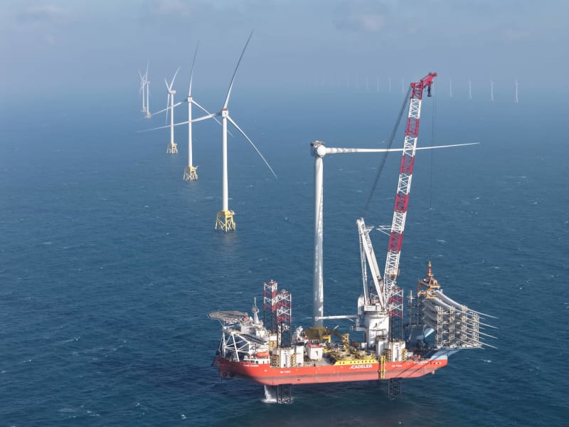 Large offshore wind turbines standing in ocean waters off Taiwan's coast during installation