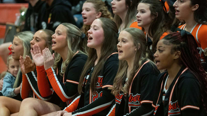 Pennsbury High School cheerleaders celebrating after winning national championship in matching jackets