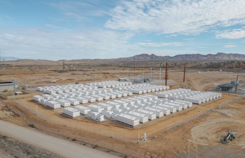Modern battery energy storage facility in Brazil with solar panels under blue sky representing clean energy future