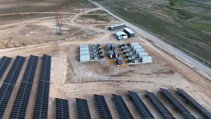 Aerial view of large solar panel array with battery storage facility in Turkish countryside
