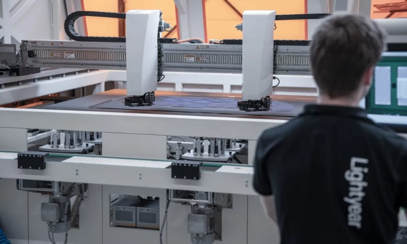 Nissan Ariya electric vehicle equipped with black solar panels on hood and roof