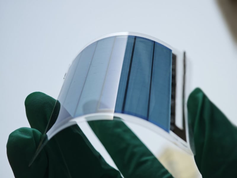 Close-up of flexible polymer solar cell material showing thin, bendable photovoltaic technology in laboratory setting