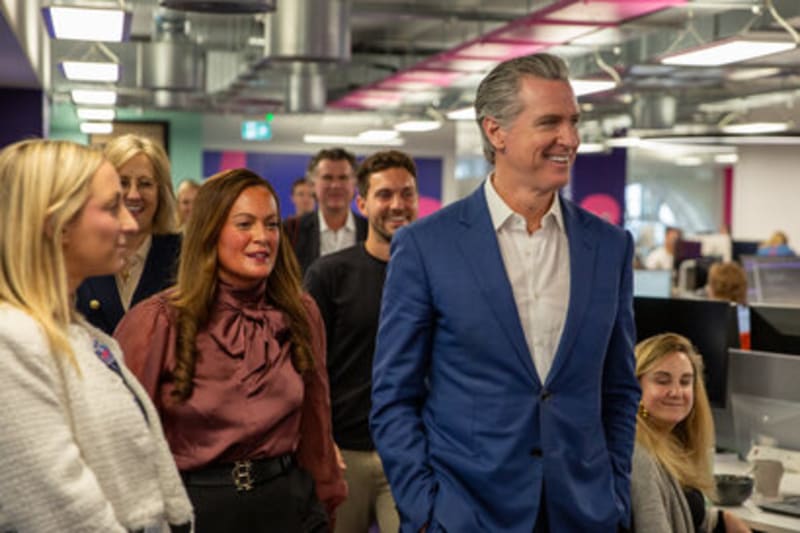 Solar panels gleaming in bright California sunshine with battery storage facility nearby