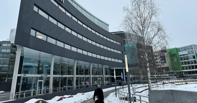 Large battery energy storage facility next to wind turbines in Finland countryside